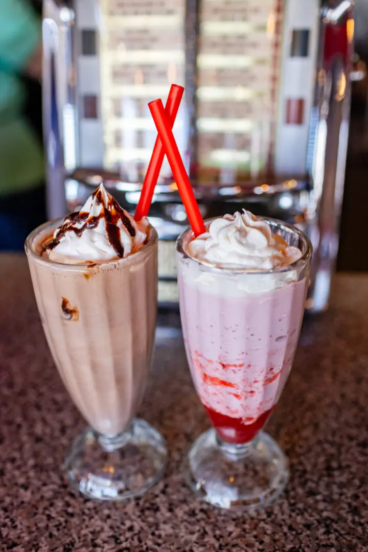 Two different drinks are sitting on a table.