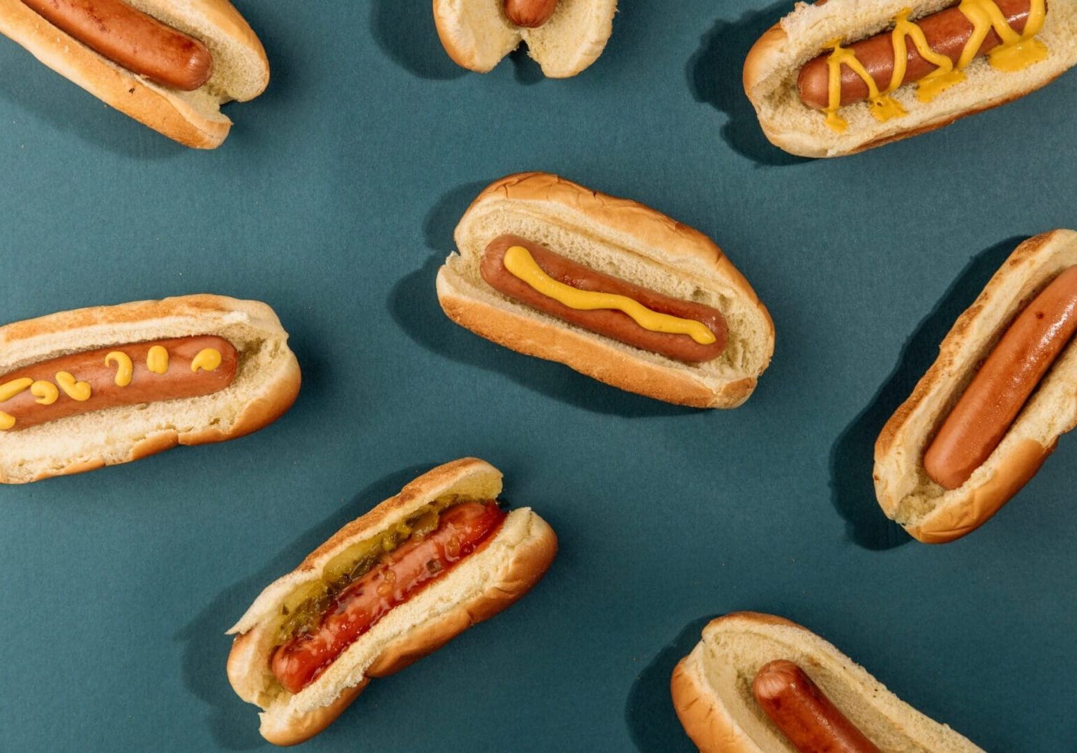 A bunch of hot dogs are on the table