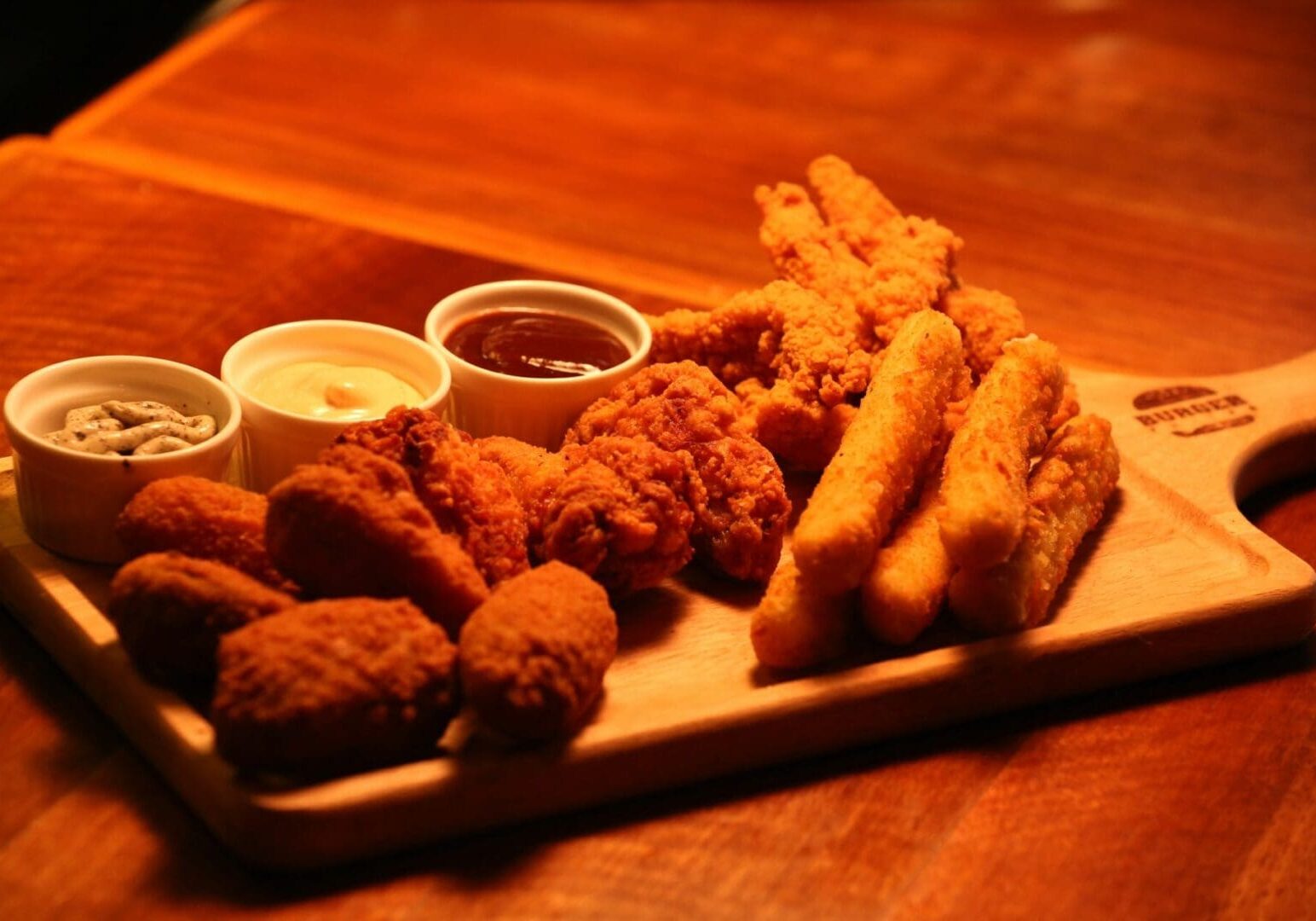 A wooden board with some fried food on it